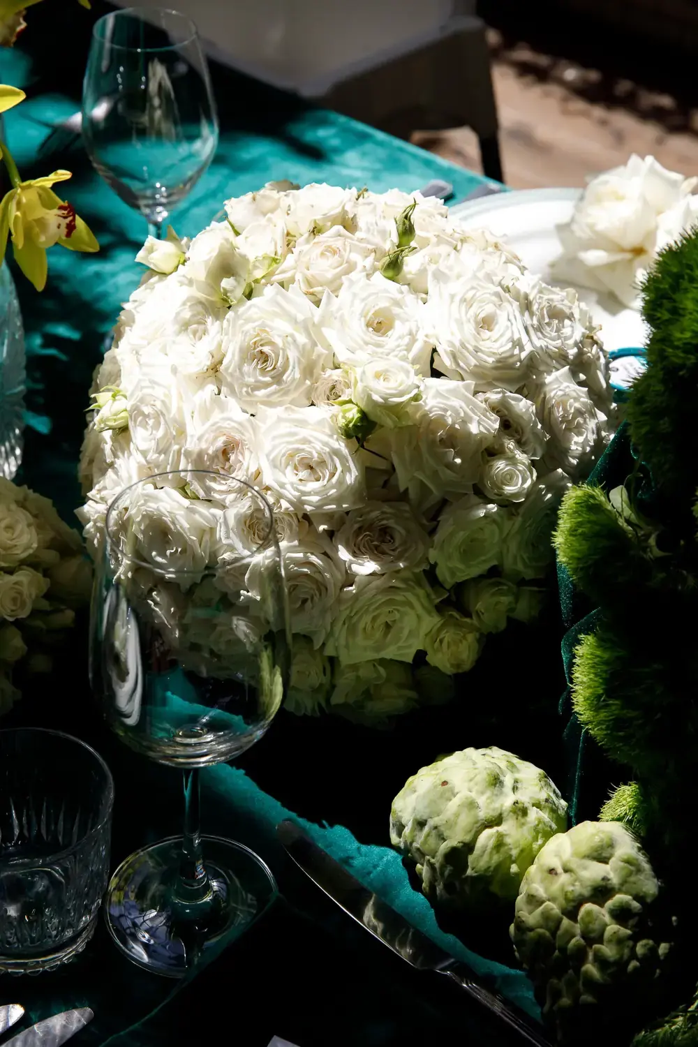 White rose floral arrangement close-up with greenery and elegant table styling details