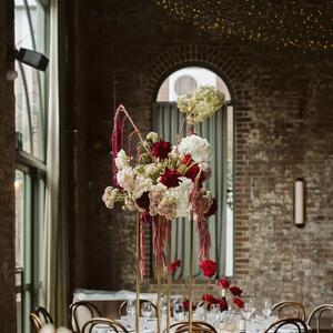 Cupid's clouds ☁️🌹 Bursting with cherry red roses, silky trails of amaranthus, and long-stem hydrangeas, this raised table piece was created with personality in mind. Unique to each table, we wanted these arrangements to stand in dramatic contrast to the industrial setting of Linseed House.
 
Bride & Groom: @charlottemcseveny & @j.mcseveny
Florals & Styling: @thegroundsfloralsbysilva 
Photographer: @amaraweddings_
Venue: @thegrounds // @thegroundsevents

#TheGroundsFloralsBySilva
